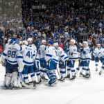 Tampa Bay Lightning hug and celebrate with each other and their goalie after their game seven win