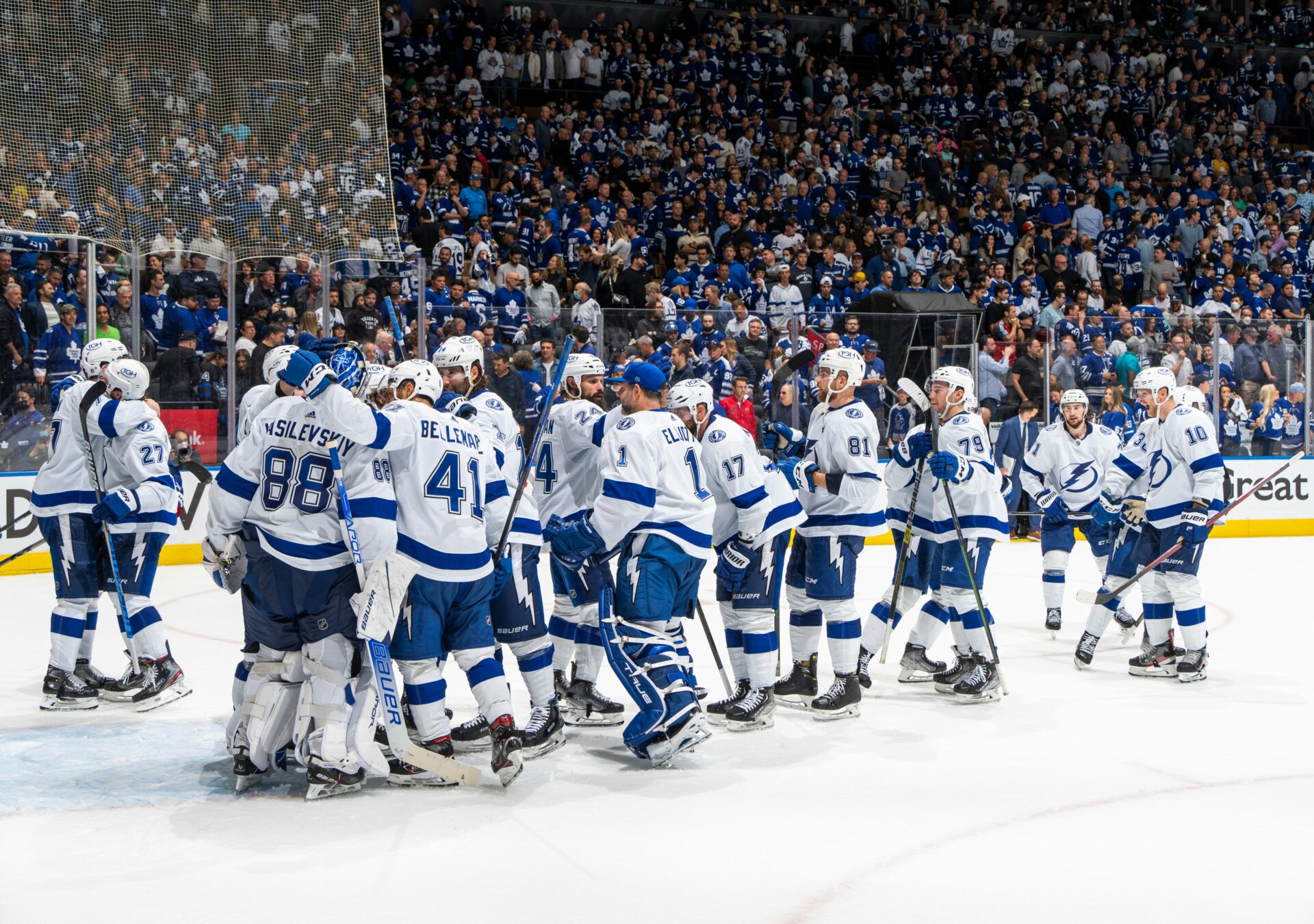 Tampa Bay Lightning hug and celebrate with each other and their goalie after their game seven win