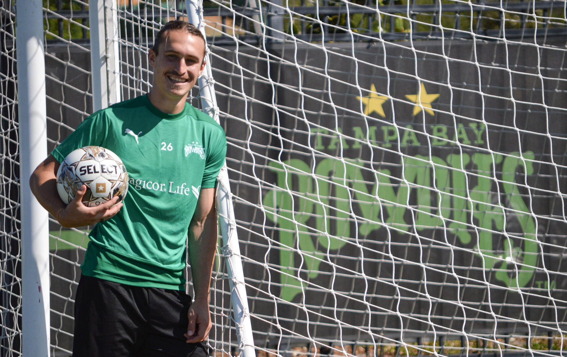 Rowdies' striker Cal Jennings leans against net with ball