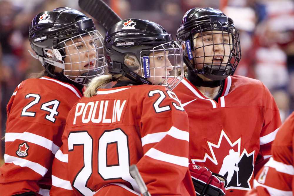 Canadian players celebrate Marie Philip Poulins goal during game action