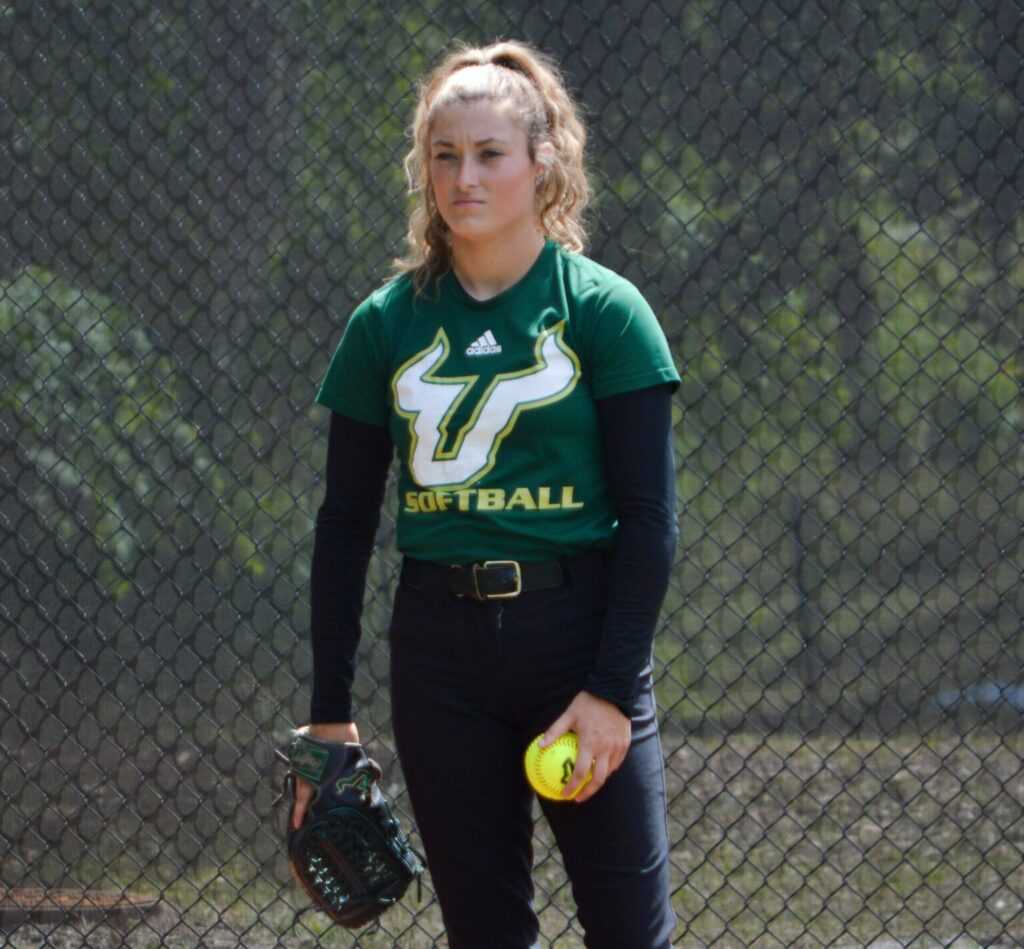 USF pitcher leaving mark in first year with team 42 USF pitcher Payton Dixon wearing a green team shirt, holds a ball in her left hand