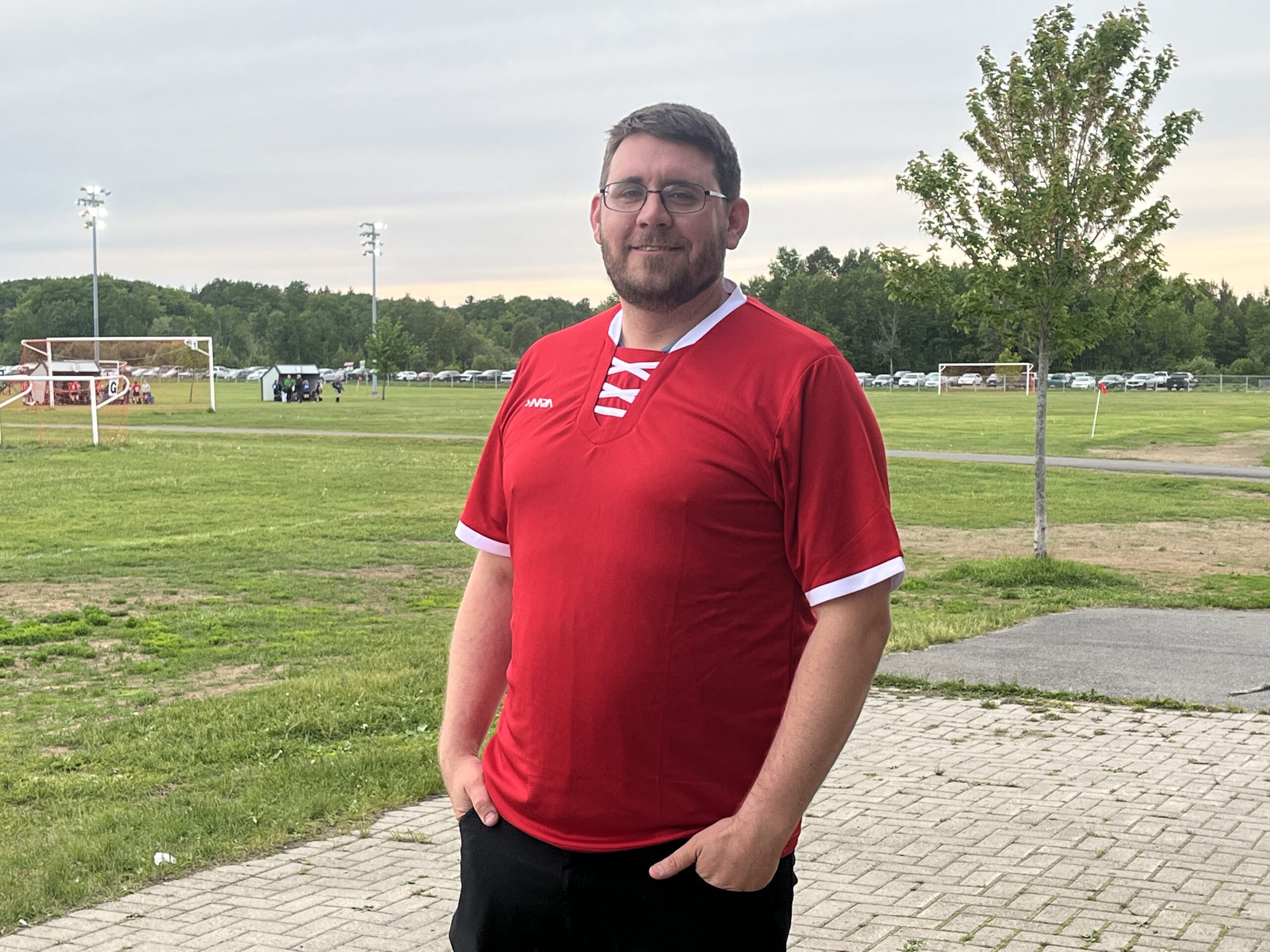 COACH'S SPOTLIGHT | Tim Marsh: From the sidelines to the soul of the game 42 Tim Marsh poses with a red jersey on