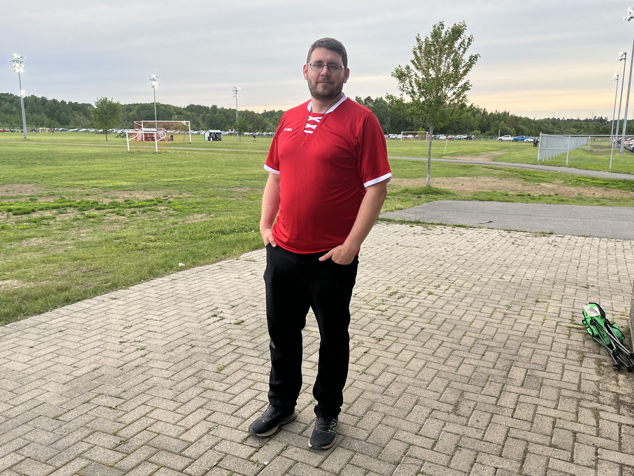 COACH'S SPOTLIGHT | Tim Marsh: From the sidelines to the soul of the game 43 Tim Marsh poses with a red jersey on