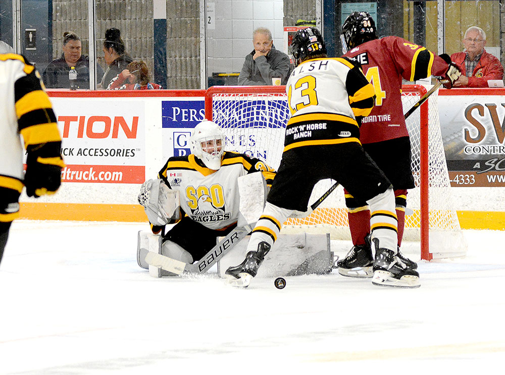 Timmins Rock battle Soo Eagles for a loose puck on Sunday, Sept. 21