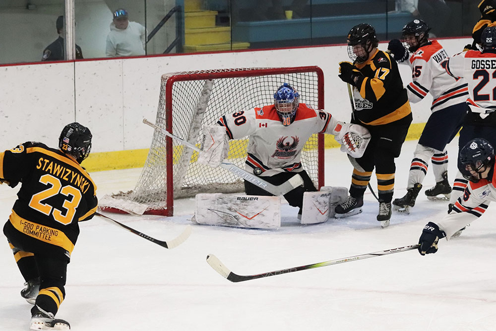 Thunderbirds complete weekend sweep of Eagles 42 Thunderbirds goalie makes a big save against Eagles forward Logan Stawizynski (#23)